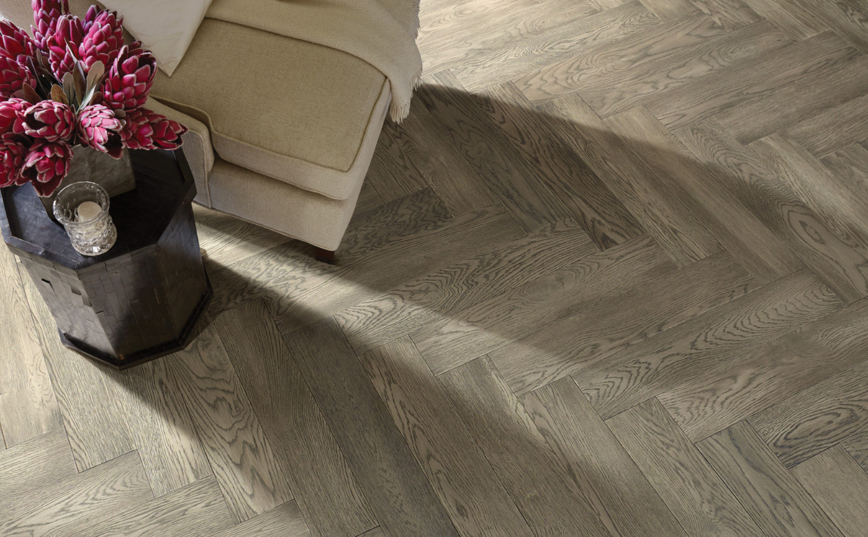 Living room with soft grey and cream furniture and carpet.